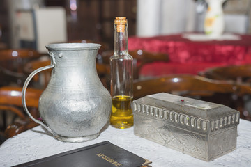 church utensil at the table, glans, the Bible on the table, ceremony of water baptism various objects needed for baptism