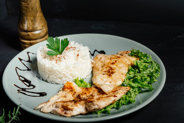 Grilled chicken breast with risotto and parsley served at bistro