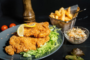 Delicious mouth watering schnitzel served with french fries at local restaurant