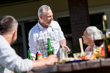 happy family talking during lunch on patio at daytime
