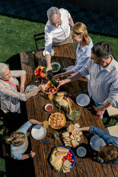 Overhead View Of Happy Family Spending Time Together On Picnic Outdoors