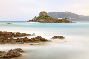 Fototapeta na wymiar Rocks and small island Kastri in Kos, Greece. Long exposure of photography, idyllic scene.