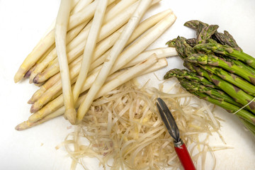 Green and peeled white Asparagus (Asparagus officinalis) in the kitchen
