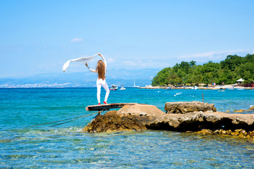 Beautiful young woman enjoying the ocean
