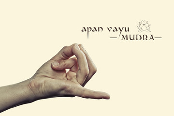 Apan vayu mudra. Yogic hand gesture. Isolated on toned background.