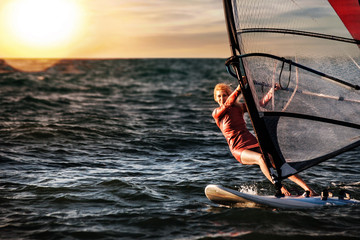 Windsurfing, Fun in the ocean, Extreme Sport. Woman lifestyle