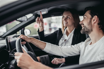 Salesperson with customer in car dealership