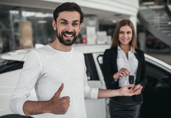 Fototapeta na wymiar Salesperson with customer in car dealership