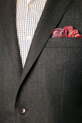 close up of man in a suit with tie and handkerchief