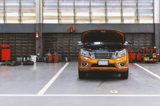 car in automobile repair service center with soft-focus in the background and over light