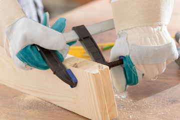 Man using bar clamp in a warkshop