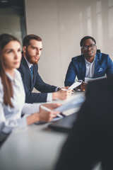 Vertical image of business colleagues cooperating to achieve better results for their company