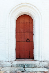rusty metal red brown old door with a forged handle ring