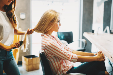 Portrait of beautiful young woman getting haircut