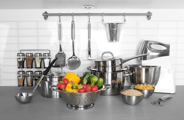 Utensils and vegetables for cooking classes on table in kitchen