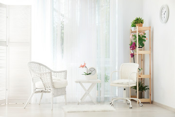 Beautiful modern veranda with cozy armchairs and coffee table