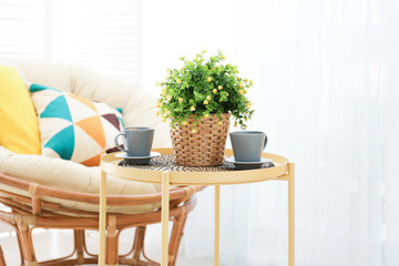Beautiful modern veranda with cozy armchair and coffee table