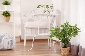 Fototapeta na wymiar Beautiful modern veranda with cozy furniture and house plants