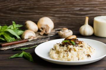 Risotto with mushrooms on a dark wooden background