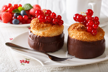 Delicious food: chocolate coconut muffins with red currant close-up. horizontal