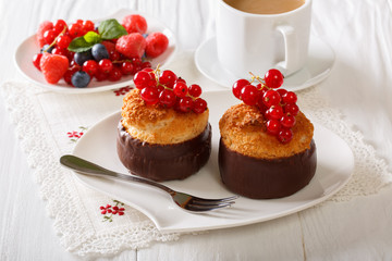 Chocolate coconut muffins, berries and coffee with milk close-up. horizontal