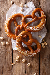 German pretzels with salt close-up on the table. Vertical top view
