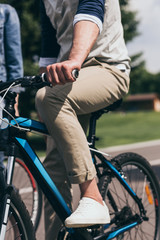 Fototapeta na wymiar partial view of man riding bicycle in summer park