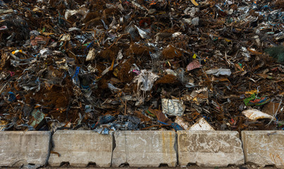 Scrap metal piled up high behind behind barrier 