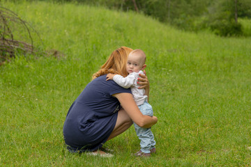 Fototapeta premium Baby girl embrassing her mother for protection
