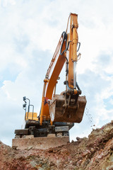 Excavator digging a trench. Work on the construction site.