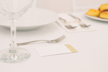 detail of a wedding or restaurant table with blank name card, copy space
