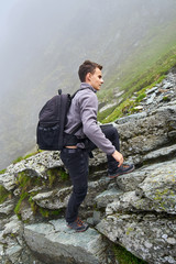 Young hiker with backpack on a trail