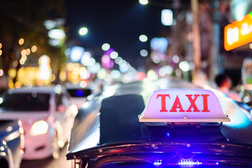 Tuk-Tuk Taxi sign with defocused lights blur , Chiang Mai, Thailand