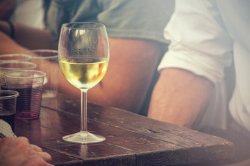 cool glass of wine on table, appetizer to drink outdoor (vintage effect)