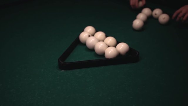 Closeup of Young Male Adult Arranged Billiard Balls on Green Table.
