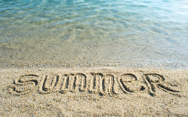 Word Summer written on the beach