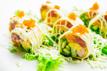 Sushi roll with tuna salmon and sweet egg inside