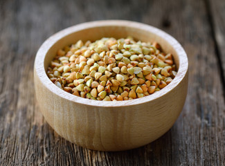 Buckwheat in wood bowl on table