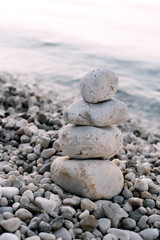 Pile of pebble stones over blue sea in the background