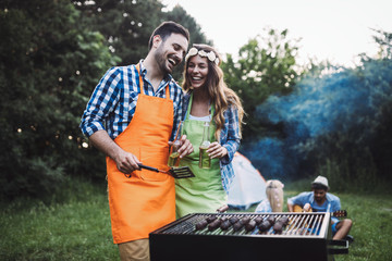 Beautiful woman and handsome man having barbecue