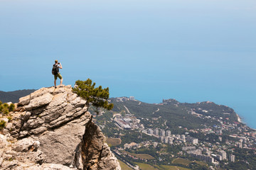 Man is takin foto of Yalta city from the top of the mountain Ai-Petri. Crimea. Russia