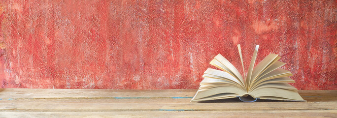 open book on red grungy background, good copy space