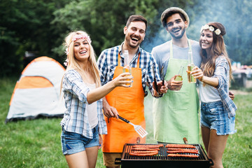 Friends spending time in nature and having barbecue