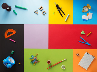school supplies at abstract colorful background