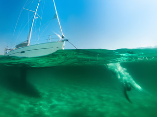 Diving someona from the boat to the sea, half under water shot