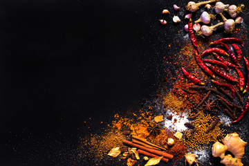 Variety Spices and herbs on black stone background, Top view with empty space background for texture. Italian food, eastern food concept.