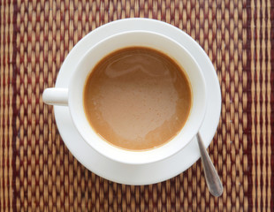 Vietnamese instant hot coffee top view on exotic Asian mat with upside down heart shape reflection