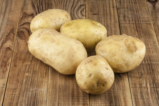 Raw, young potatoes on a wooden table
