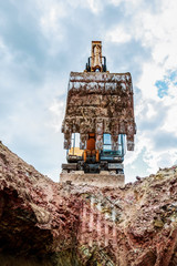 The excavator lifted the bucket. Bottom view.