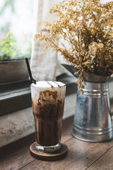 ice coffee on table,coffee in highball Glass,caffeine addicted beverage,vintage color tone